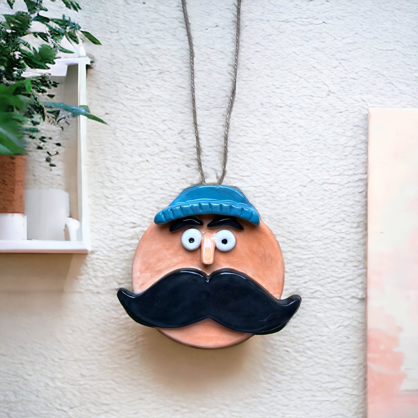 Decorazione da parete con volto in ceramica